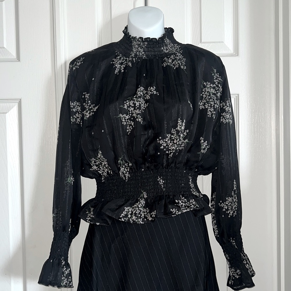 Black Long-sleeved blouse ruched at neck, waist and sleeves.